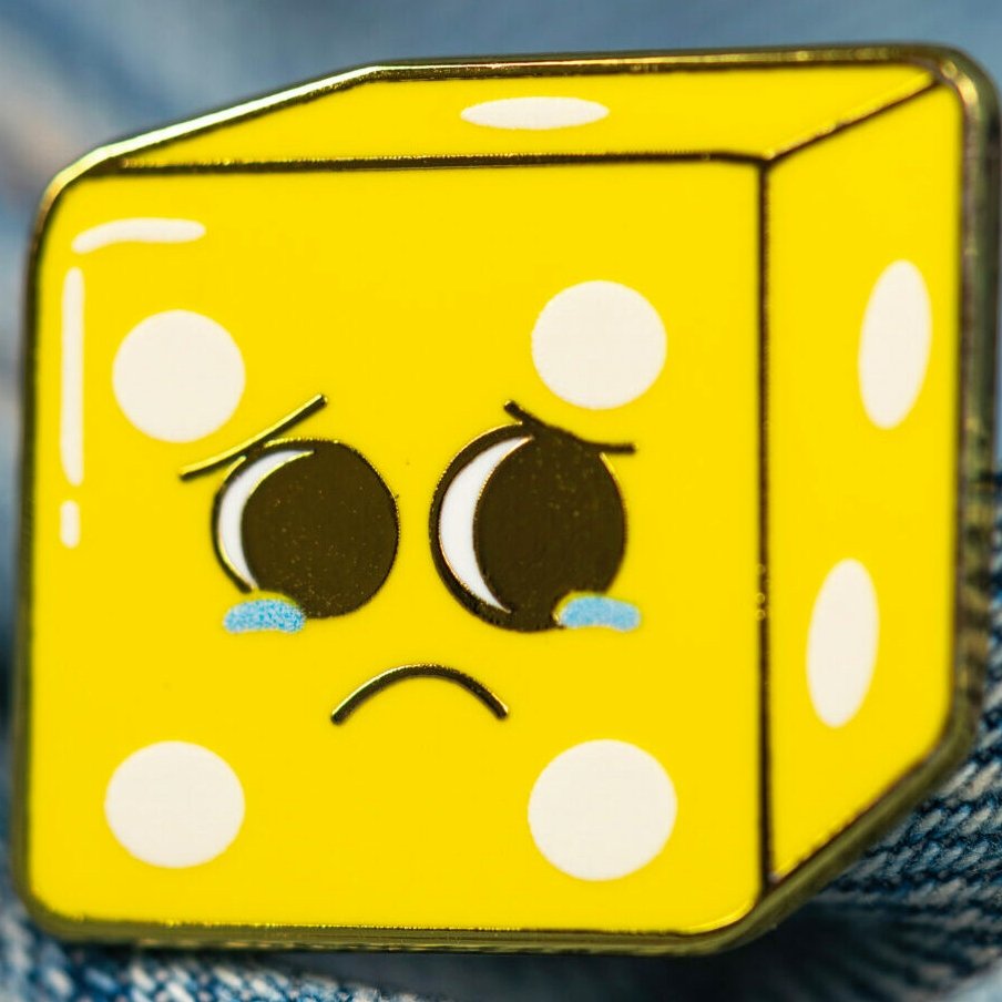 Pin's émaillé jaune - Le Dé Pité